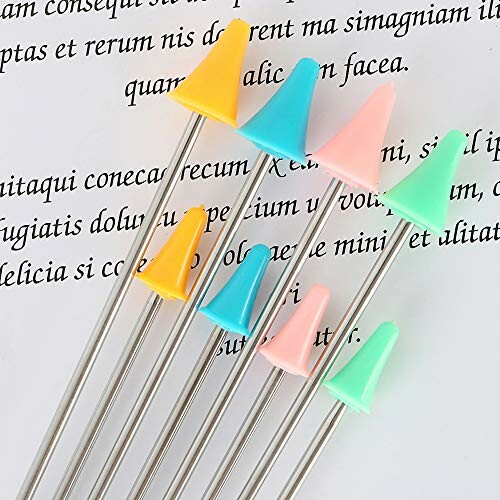 Colorful knitting needle caps on a page with text.