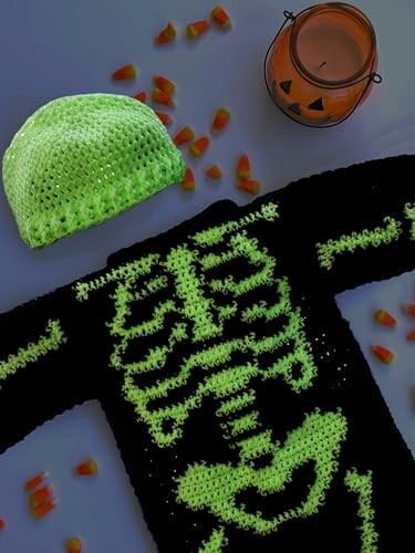 Glow-in-the-dark skeleton sweater with candy and pumpkin candle holder.