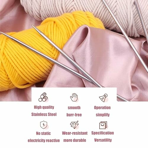 Stainless steel knitting needles with yellow and beige yarn on satin fabric.