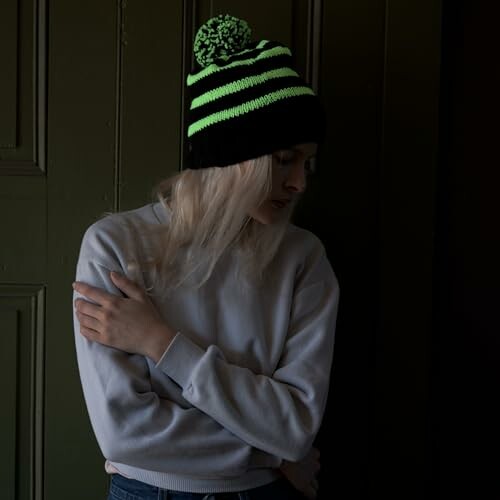 Woman wearing a striped beanie and sweater