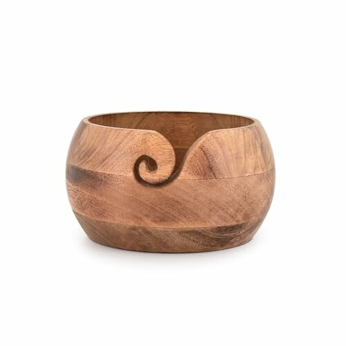 Wooden yarn bowl with a spiral cutout.